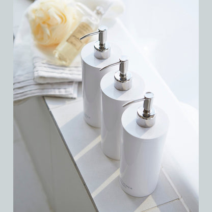 Aerial view of Yamazaki Home white Shampoo, Conditioner, and Body Soap in bathroom.