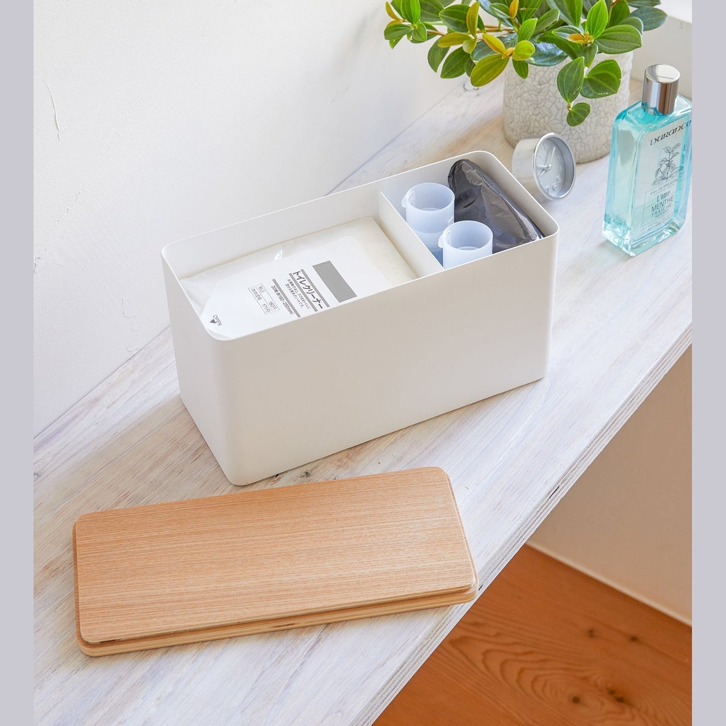 White Countertop Organizer holding items with lid off on counter by Yamazaki Home.