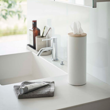 Large White Yamazaki Home Round Tissue Case on a bathroom sink counter