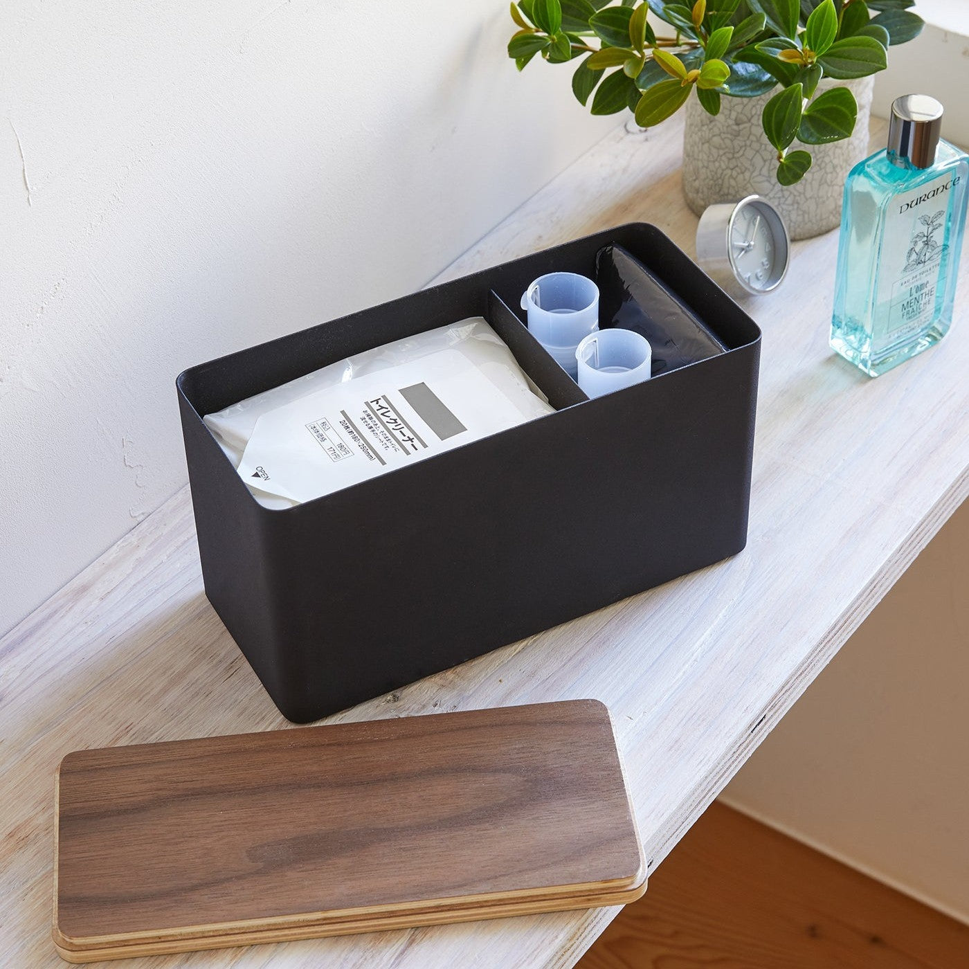 Black Countertop Organizer holding items with cover off on shelf by Yamazaki Home.