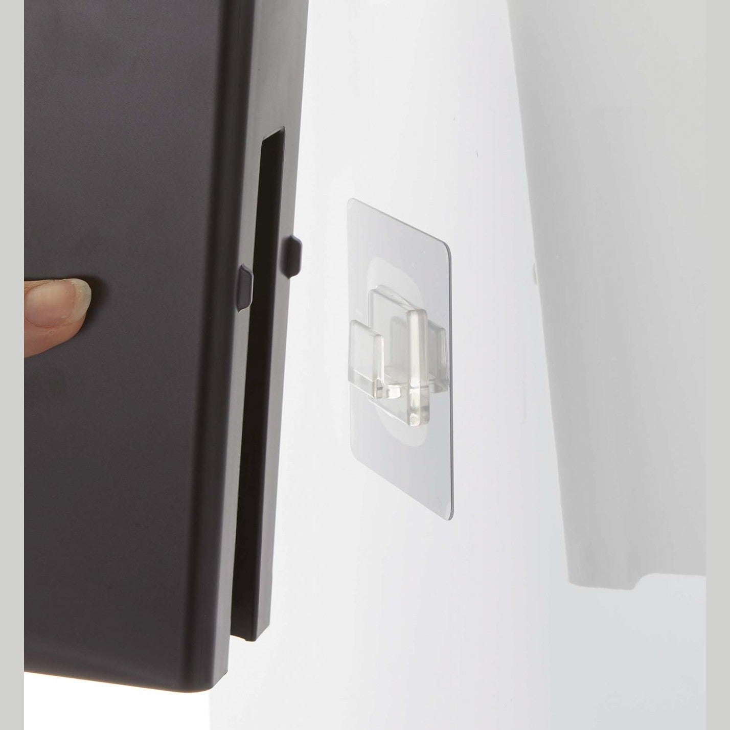 Close up of film hook attachment on black Yamazaki Home square soap dispenser