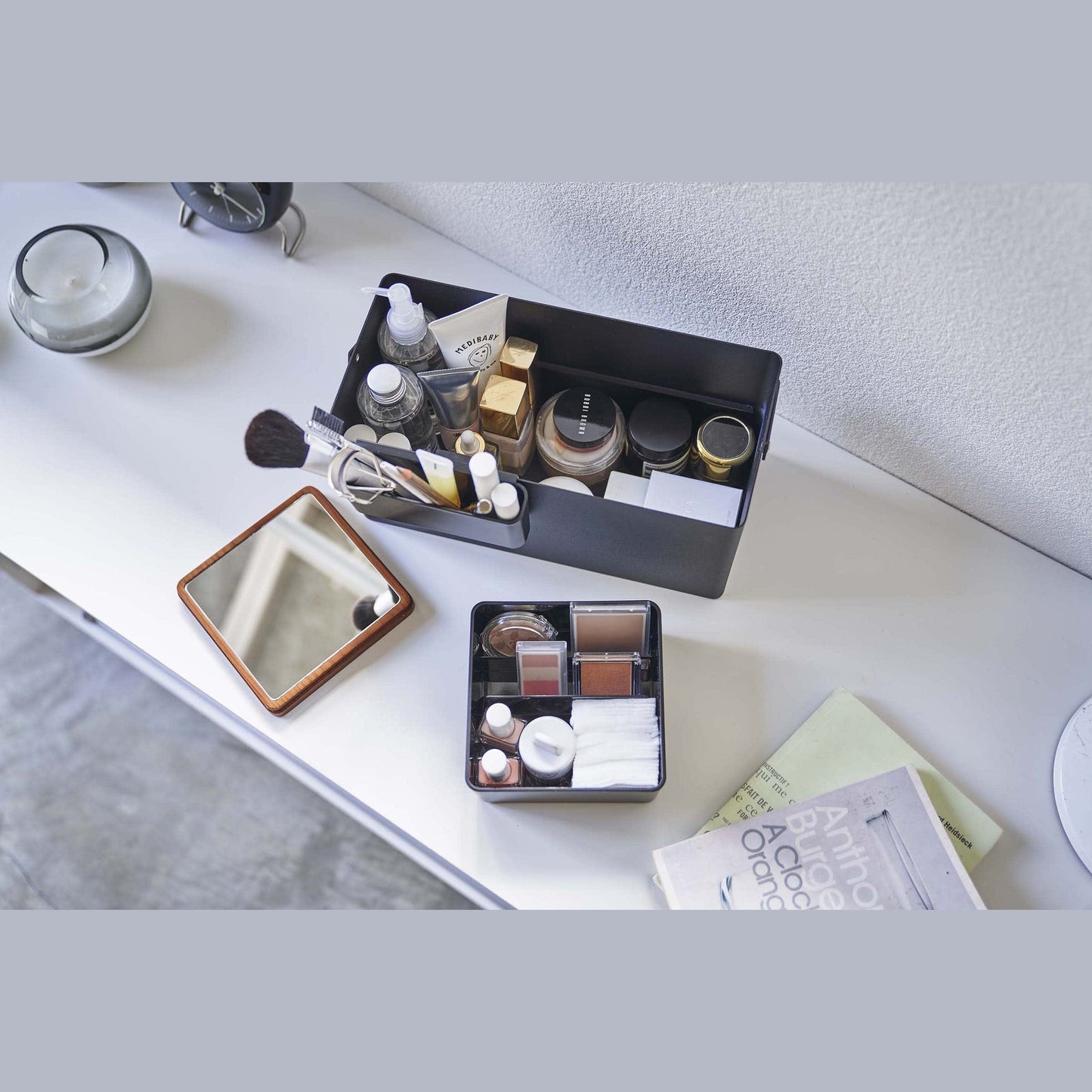 Aerial view of open black Makeup Organizer holding makeup products by Yamazaki Home.