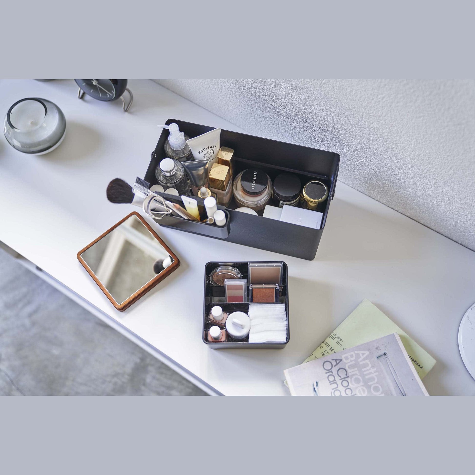 Aerial view of open black Makeup Organizer holding makeup products by Yamazaki Home.