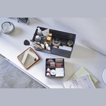 Aerial view of open black Makeup Organizer holding makeup products by Yamazaki Home.