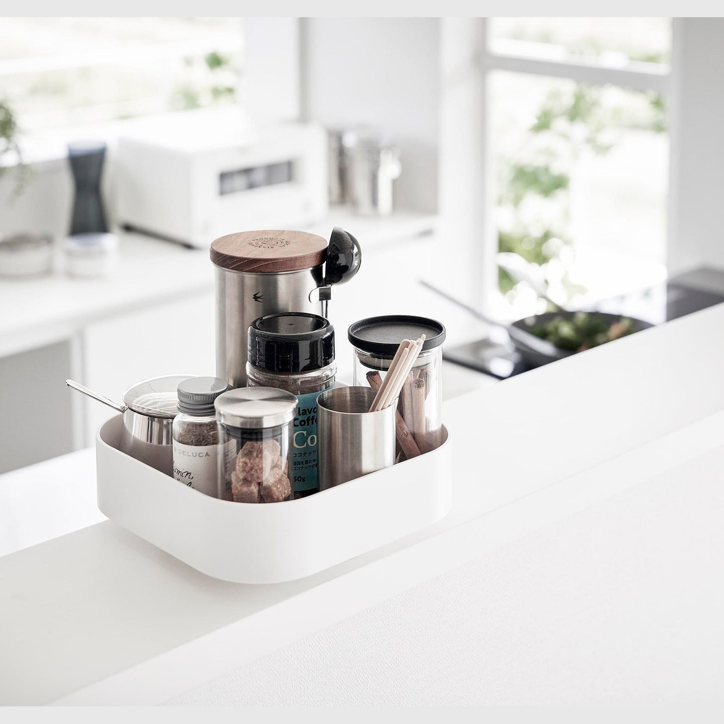 White Yamazaki Home Rotating Storage Tray with coffee accessories stored