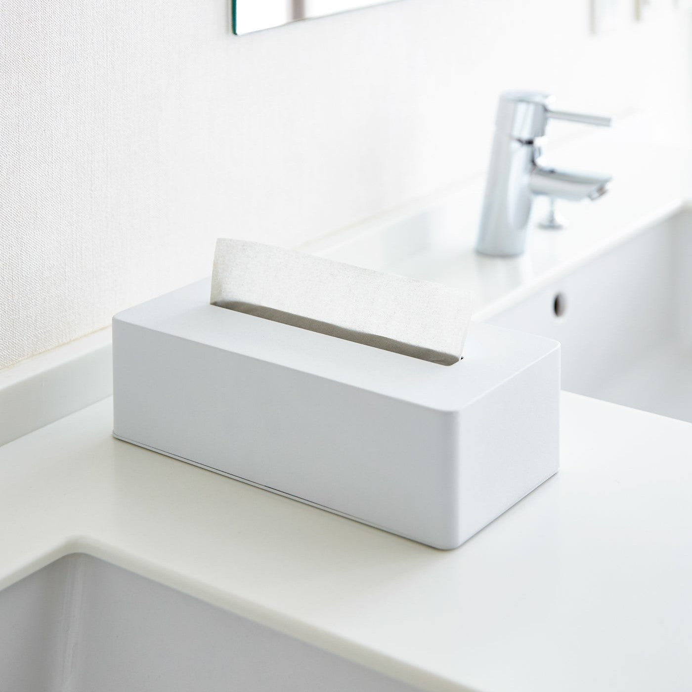 White Tissue Case on bathroom sink countertop by Yamazaki Home.