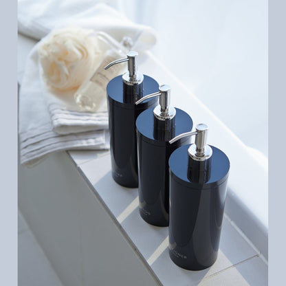 Aerial view of black Shampoo Dispenser on bathtub edge by Yamazaki Home.