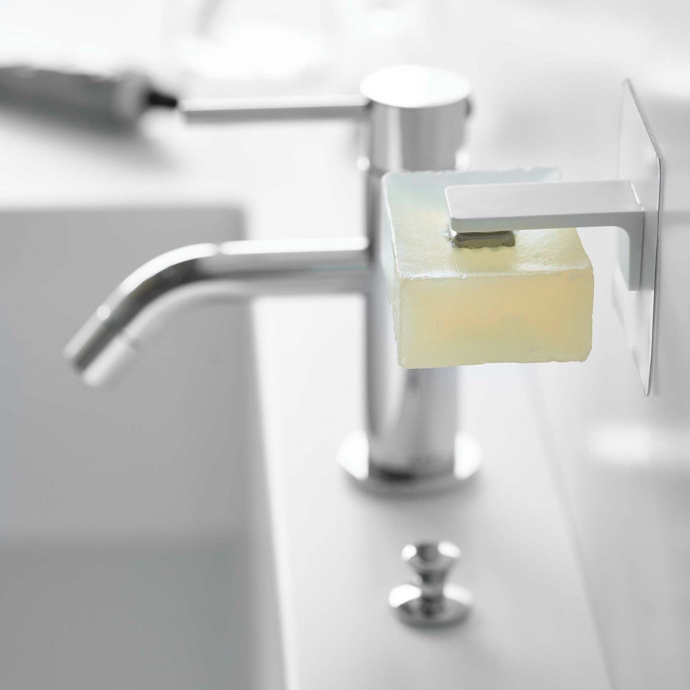 White Yamazaki Home Magnetic Soap Holder installed next to sink