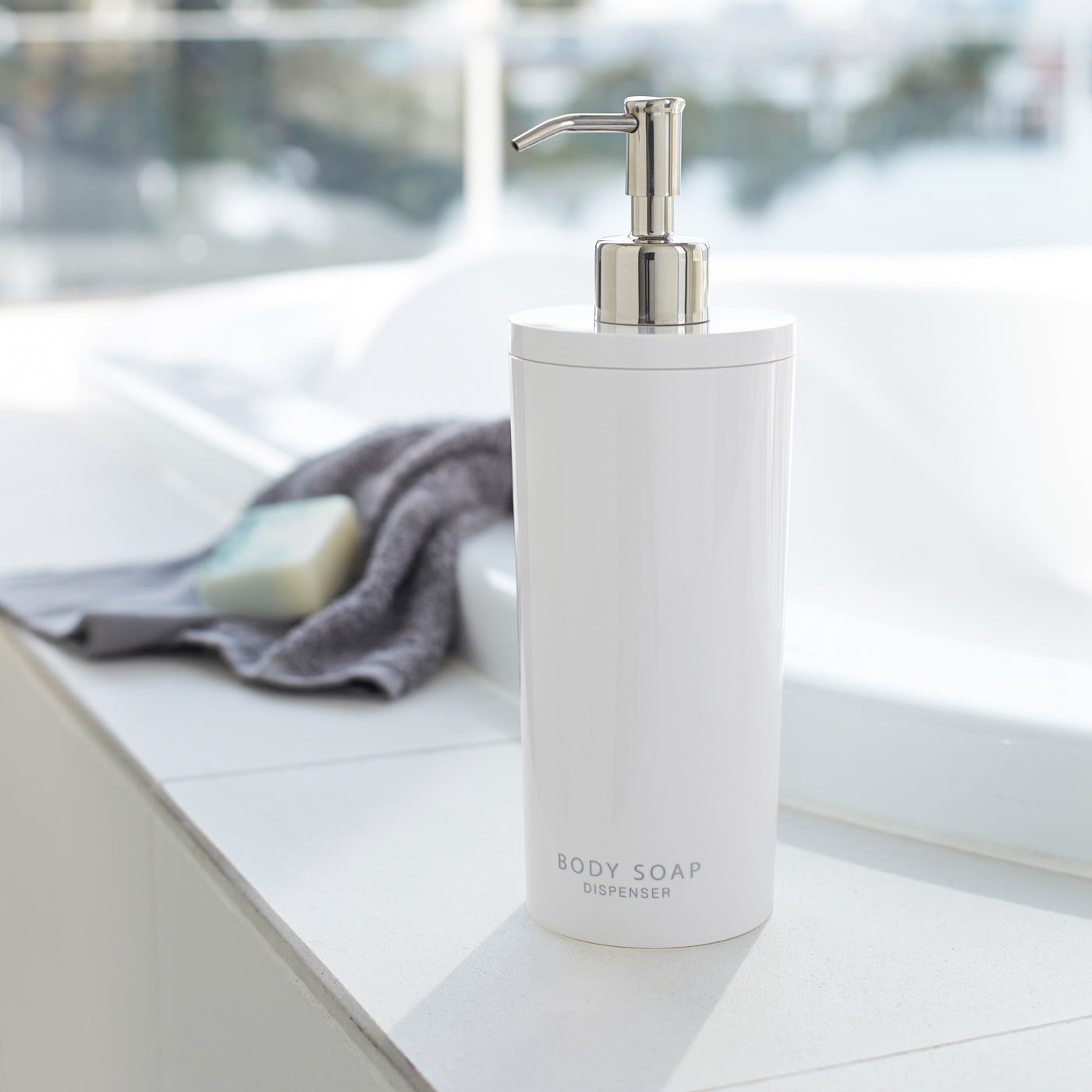 White Body Soap Dispenser in bathroom by Yamazaki Home.