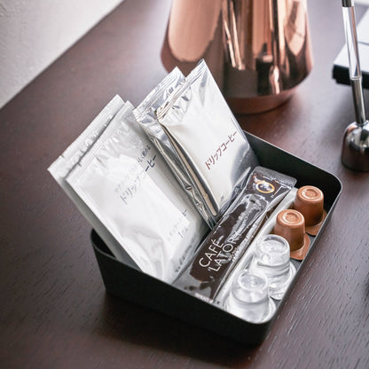Aerial view of black Accessory Tray holding coffee items by Yamazaki Home.