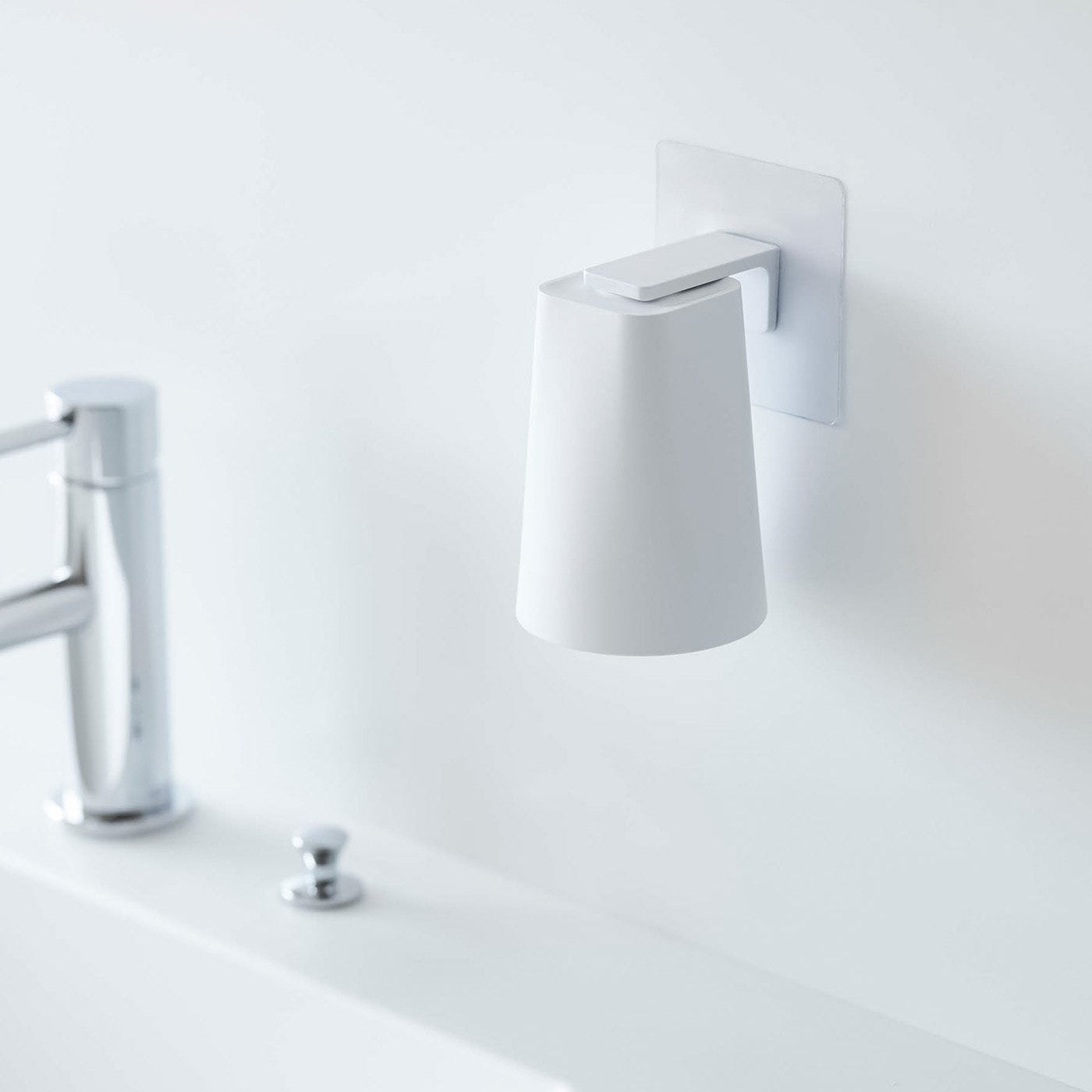 White Yamazaki Home traceless adhesive magnetic cup installed next to sink