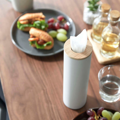 Close up of Small white Yamazaki Home Round Tissue Case on a dining table