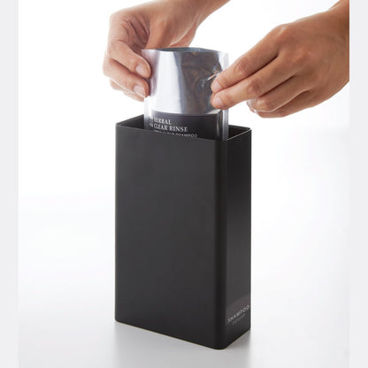 Side view of Shampoo Dispenser getting filled with shampoo on white background by Yamazaki Home.