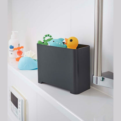 Black Yamazaki Self-Draining Bathroom Organizer filled with bath toys