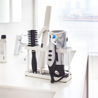 White Hair Tool and Styling Accessory Organizer holding hair tools in bathroom by Yamazaki Home.