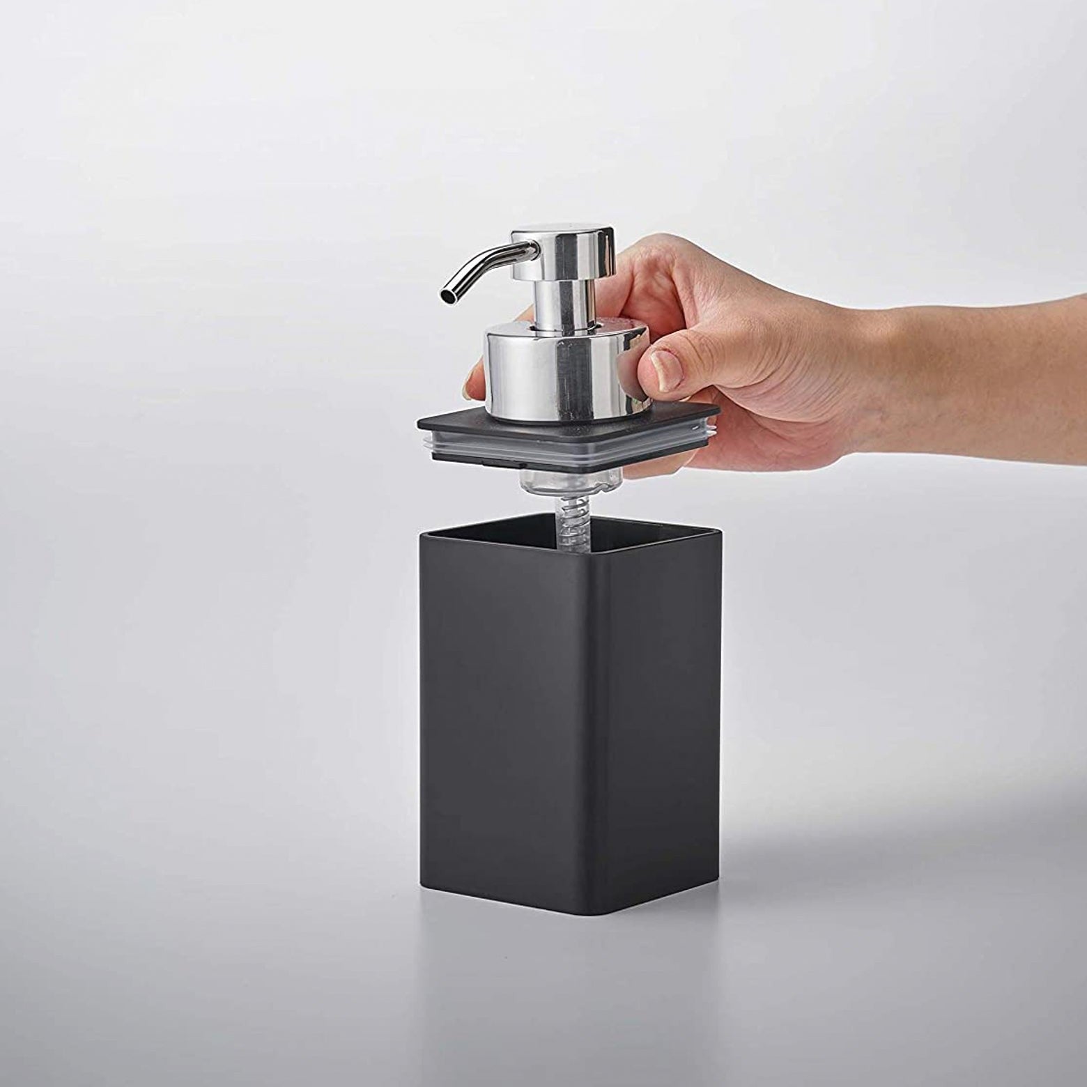 Black Foaming Soap Dispenser with top removed on white background by Yamazaki Home.