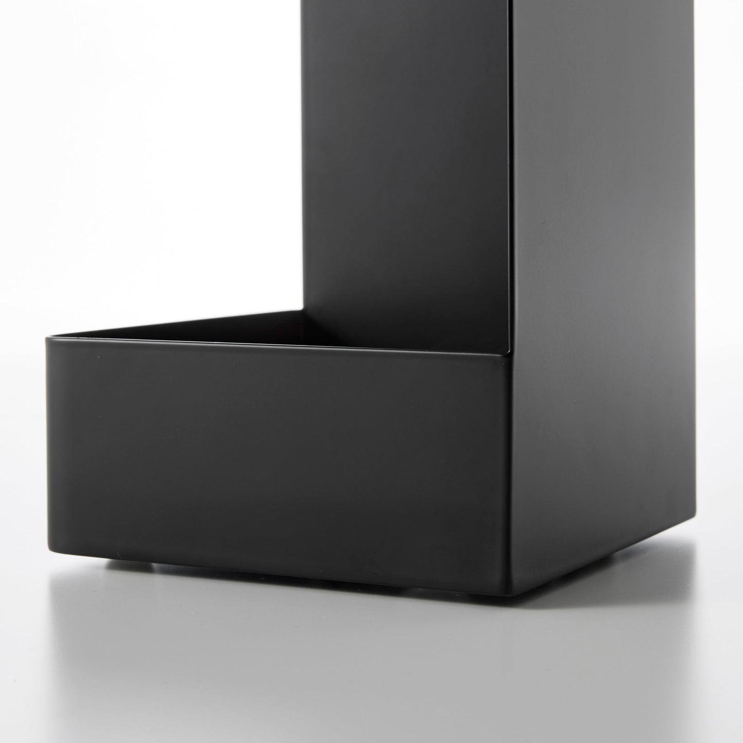 Close up view of bottom of black Yamazaki Home Rolling Bathroom Organizer