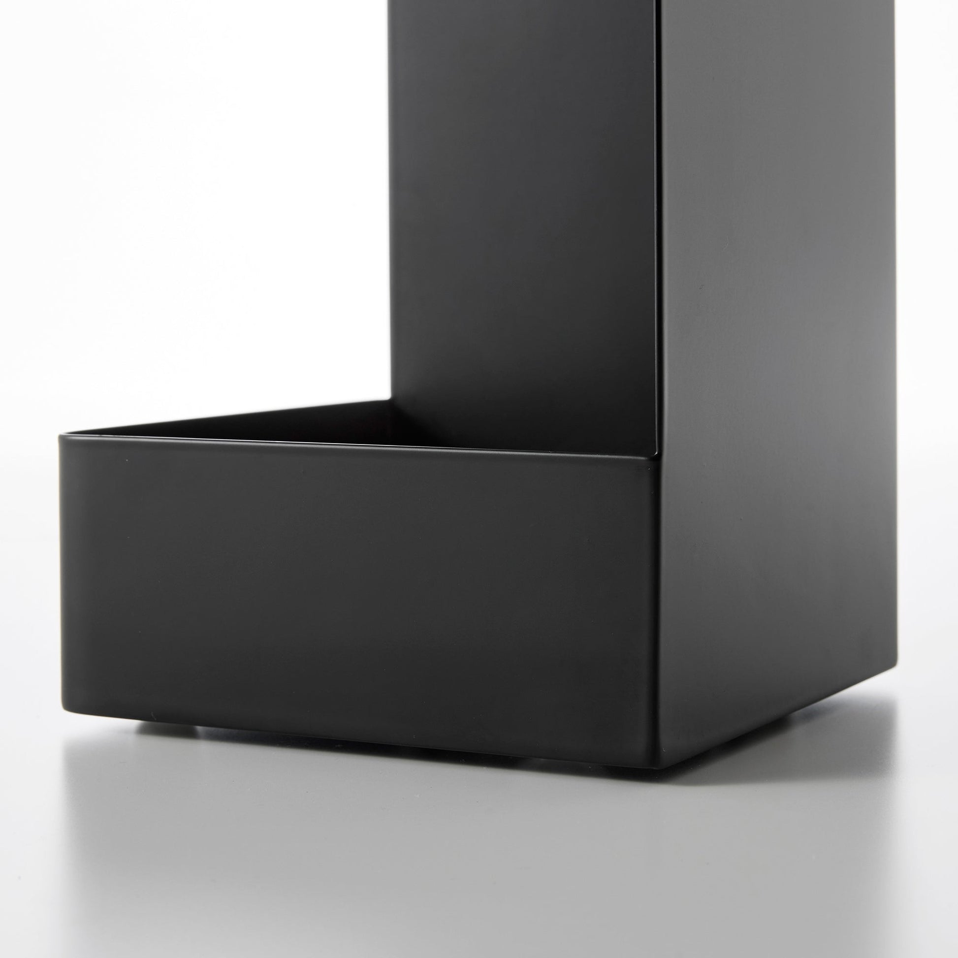 Close up view of bottom of black Yamazaki Home Rolling Bathroom Organizer