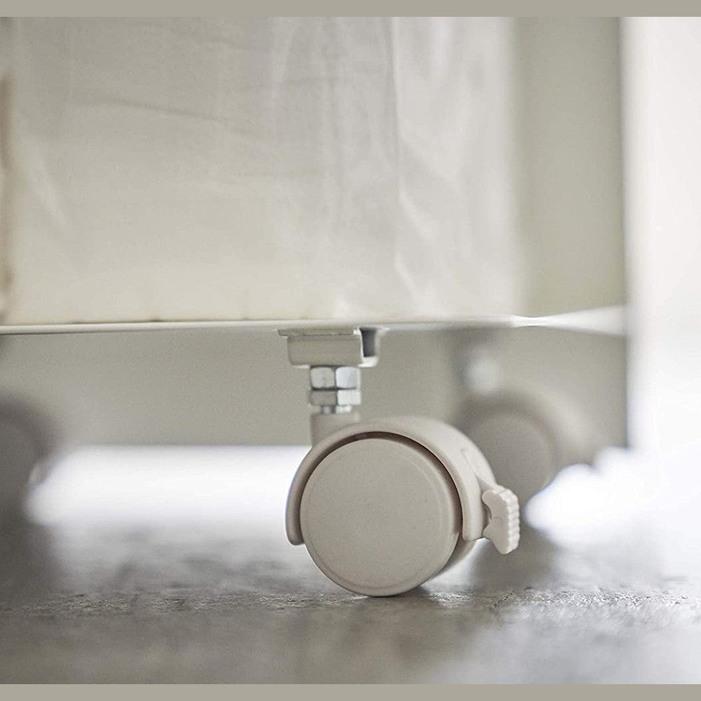 Close up bottom view of white Rolling Bathroom Organizer wheels by Yamazaki Home.