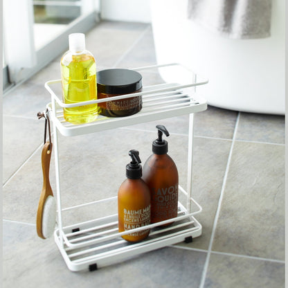 White Shower Caddy holding cleaning items in bathroom by Yamazaki Home.