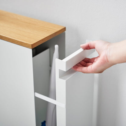 Close up of white Yamazaki Home Pull-Out Bathroom Storage Cabinet handle