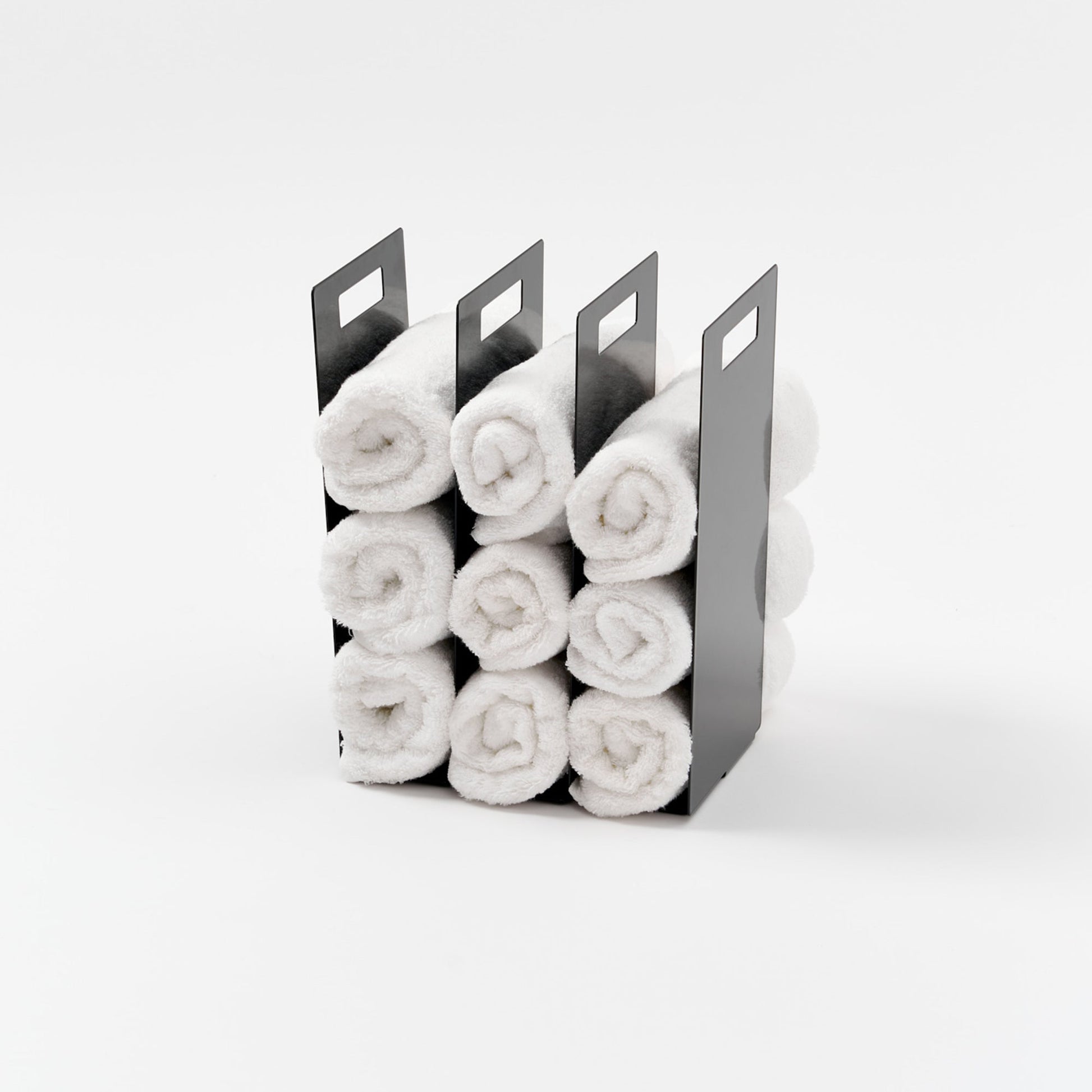 Yamazaki Home Towel Storage Organizer with props, set against a white background.
