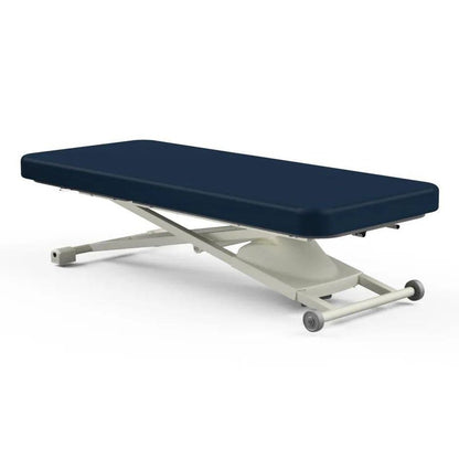 Oakworks Proluxe Flat Top electric massage table with navy blue padding and beige X-frame scissor lift