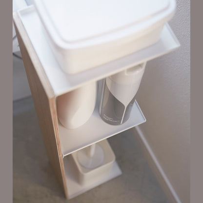 Close up aerial view of Toilet Paper Stocker holding bathroom accessories in bathroom by Yamazaki Home.