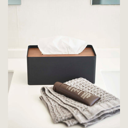 Front view of Yamazaki Home black Tissue Case holding tissues on bathroom countertop.