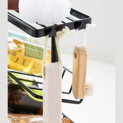 Close up view of black Freestanding Shower Caddy hooks holding beauty items by Yamazaki Home.