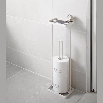 White Toilet Paper Stocker holding phone, clock and toilet paper in bathroom by Yamazaki home.