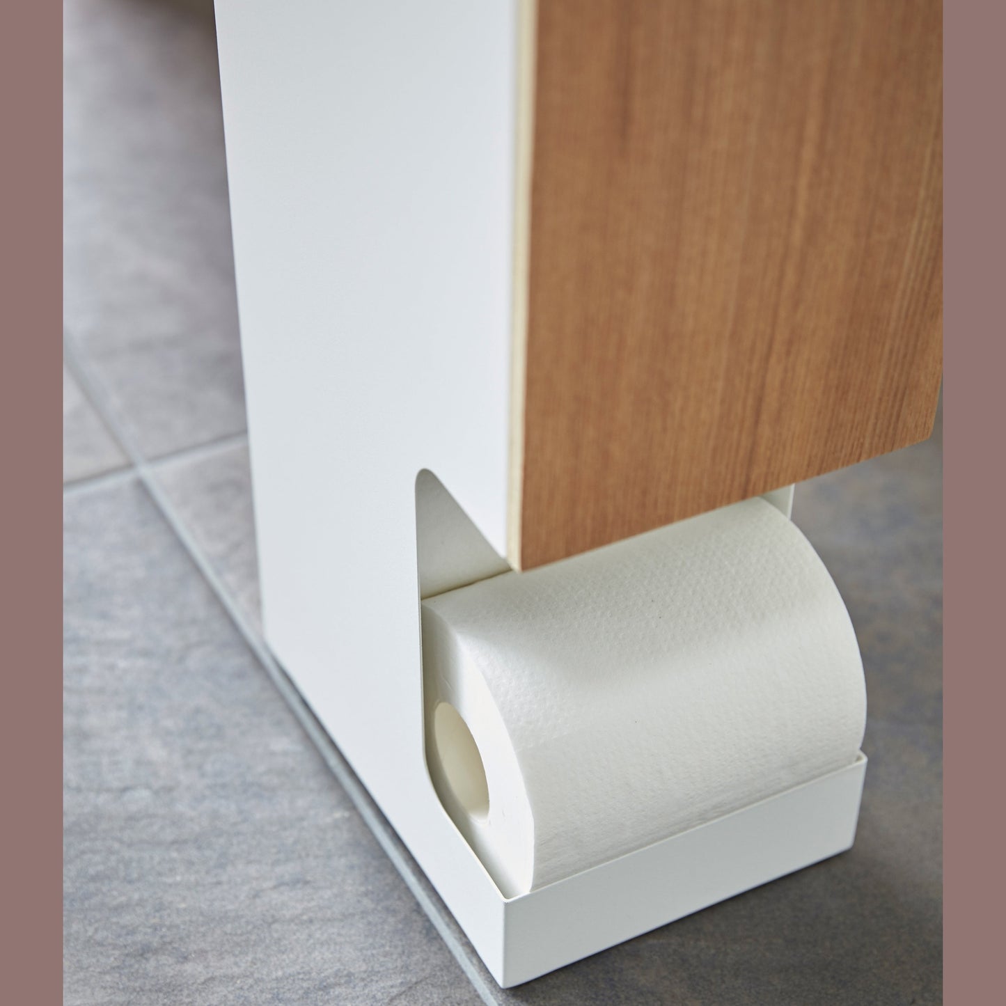 Close up bottom view of Toilet Paper Stock dispensing toilet paper roll by Yamazaki home.
