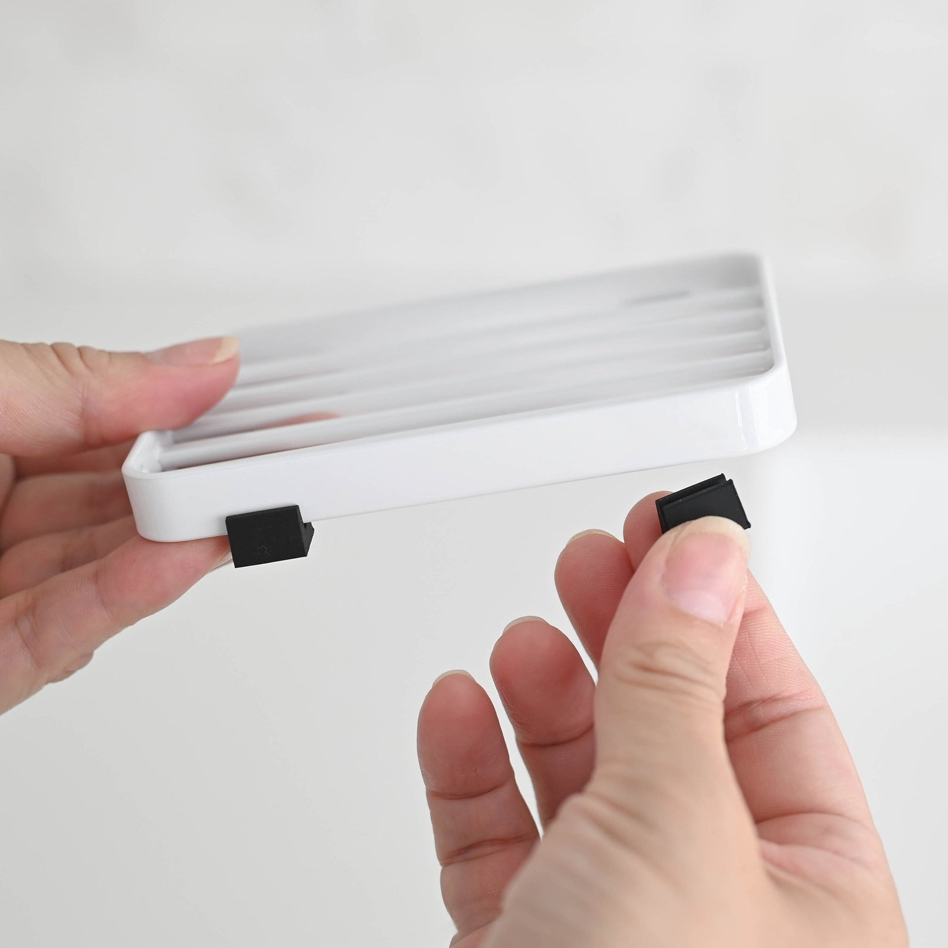 Close-up view of White Slotted Soap Tray showing silicon cushions by Yamazaki Home.