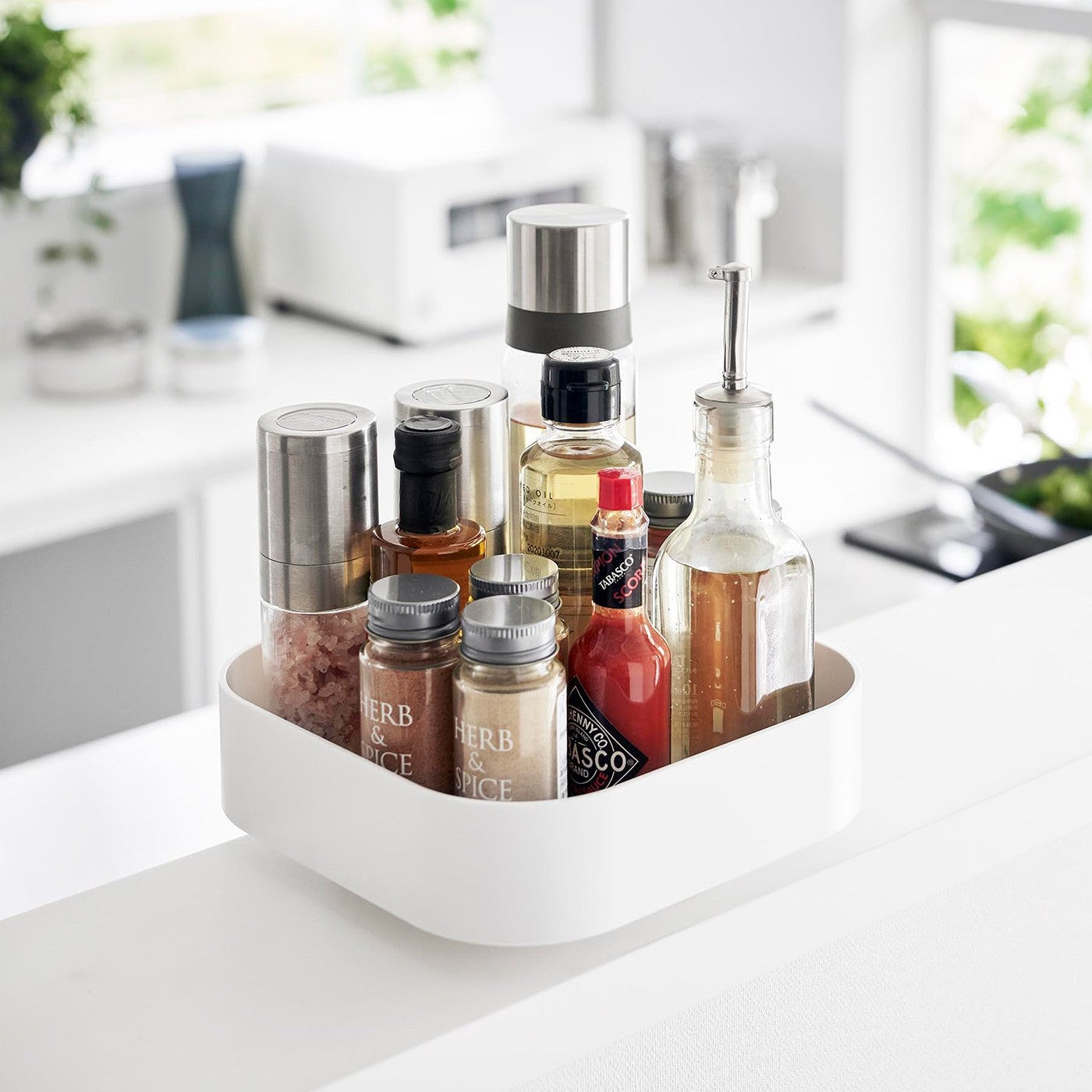 White Yamazaki Home Rotating Storage Tray with spices and oil stored