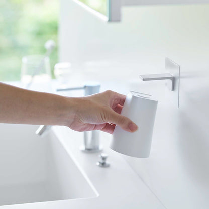 Removing white Yamazaki Home traceless adhesive magnetic cup installed next to sink