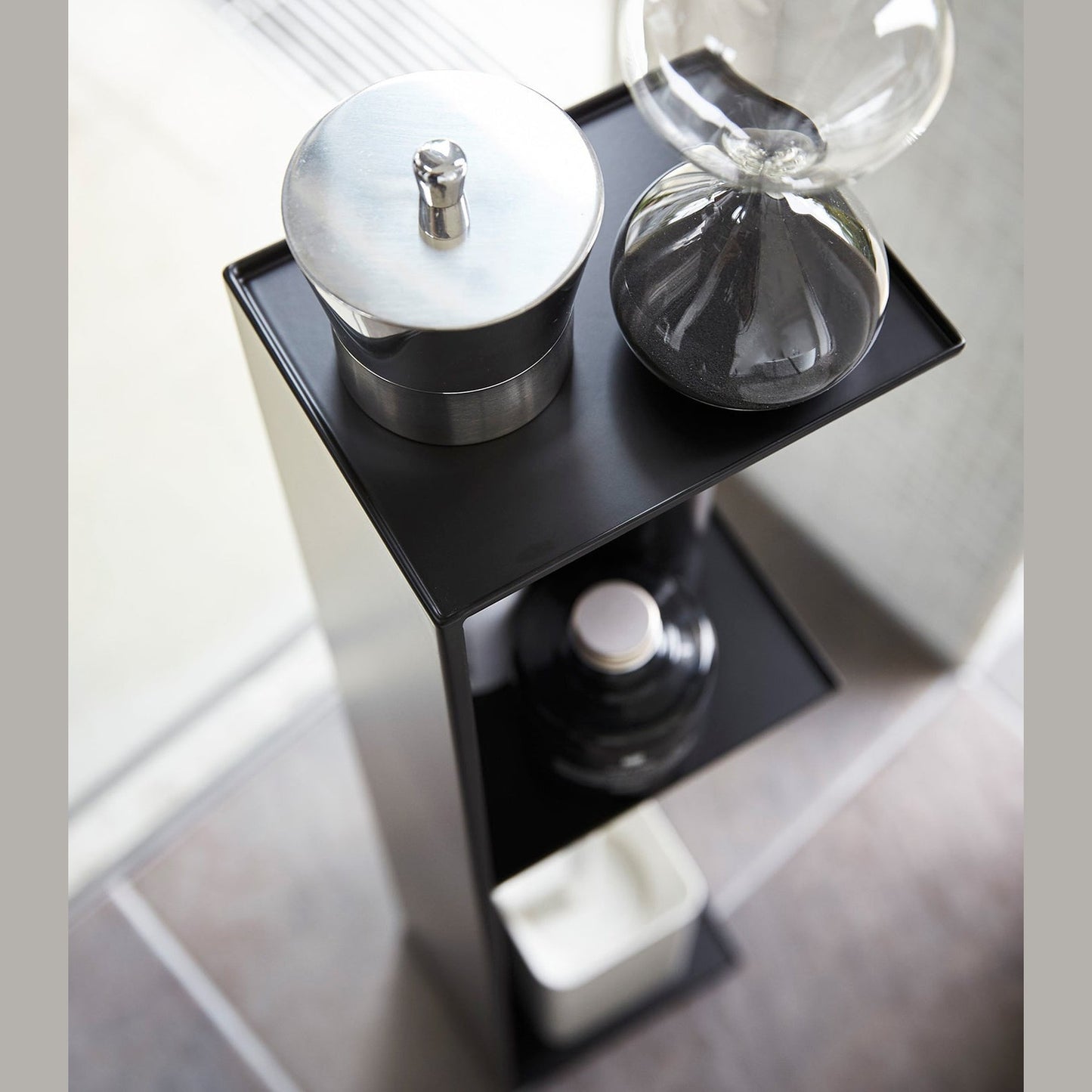 Aerial view of Yamazaki Home black Toilet Organizer holding bathroom items.