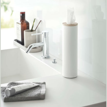 Small white Yamazaki Home Round Tissue Case on a sink counter