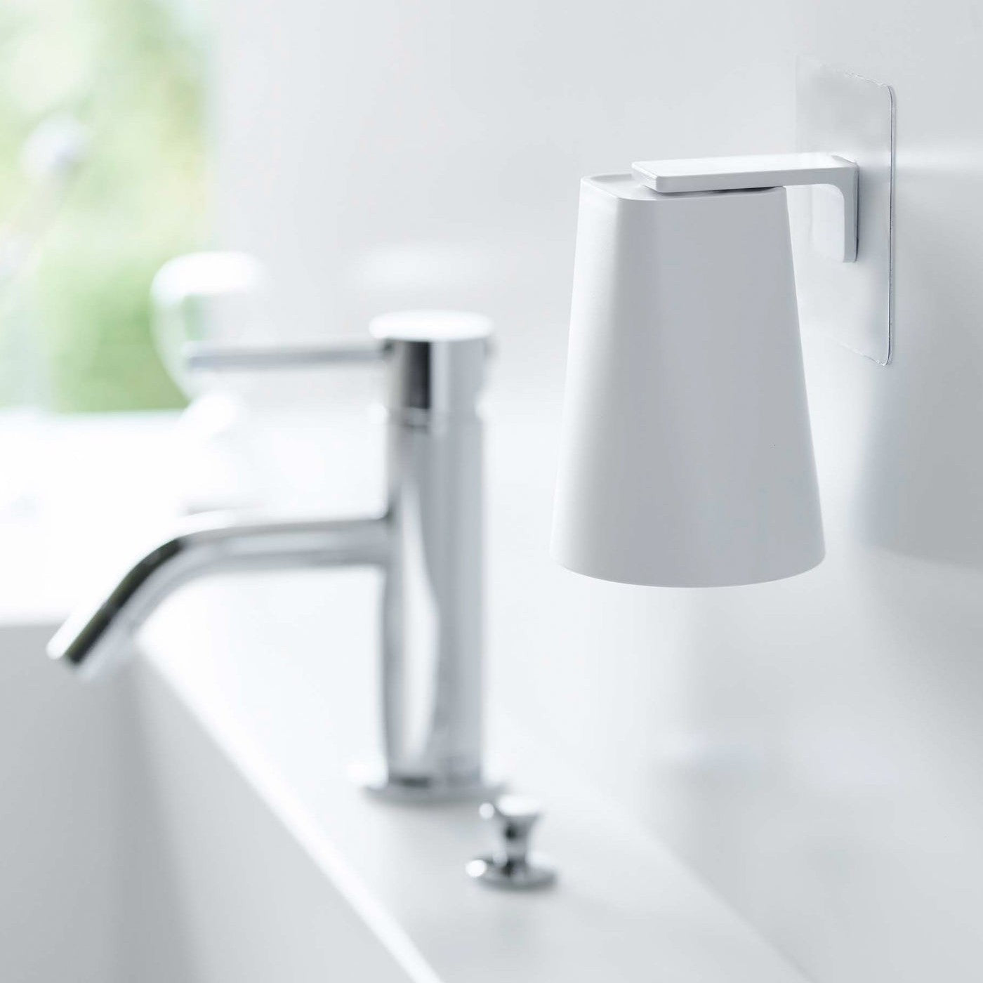 White Yamazaki Home traceless adhesive magnetic cup installed next to sink