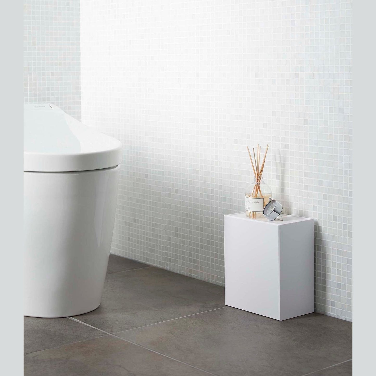 White Wall-Mount Storage on floor in bathroom by Yamazaki Home.