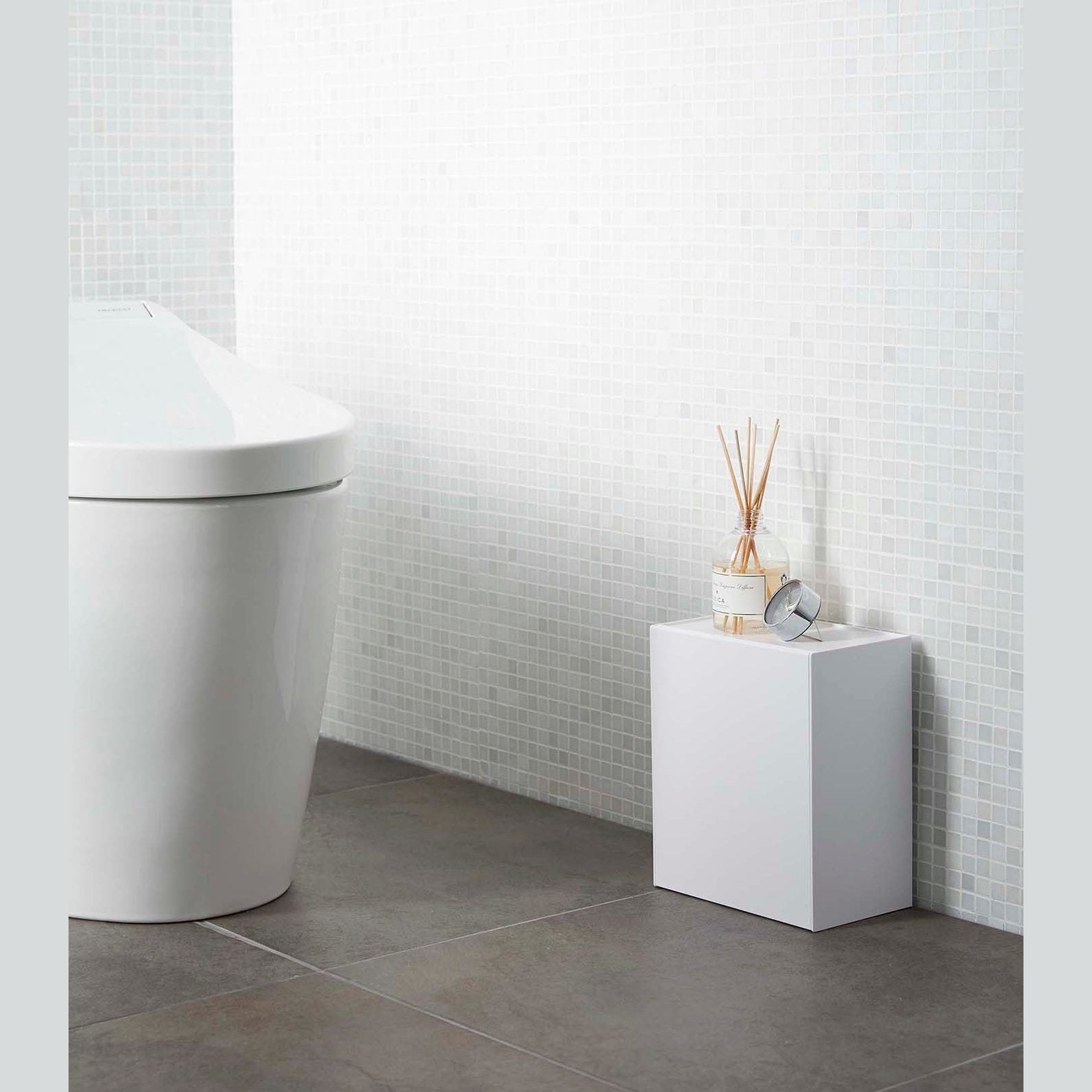 White Wall-Mount Storage on floor in bathroom by Yamazaki Home.