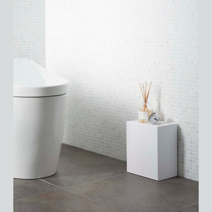 White Wall-Mount Storage on floor in bathroom by Yamazaki Home.