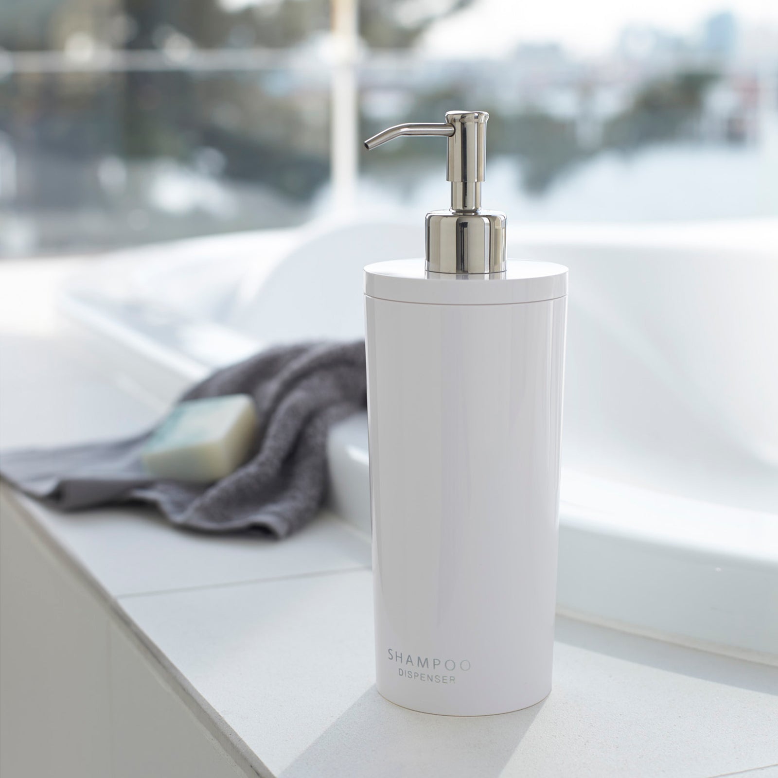 White Yamazaki Shampoo Liquid Soap Pump Dispenser near a sink.