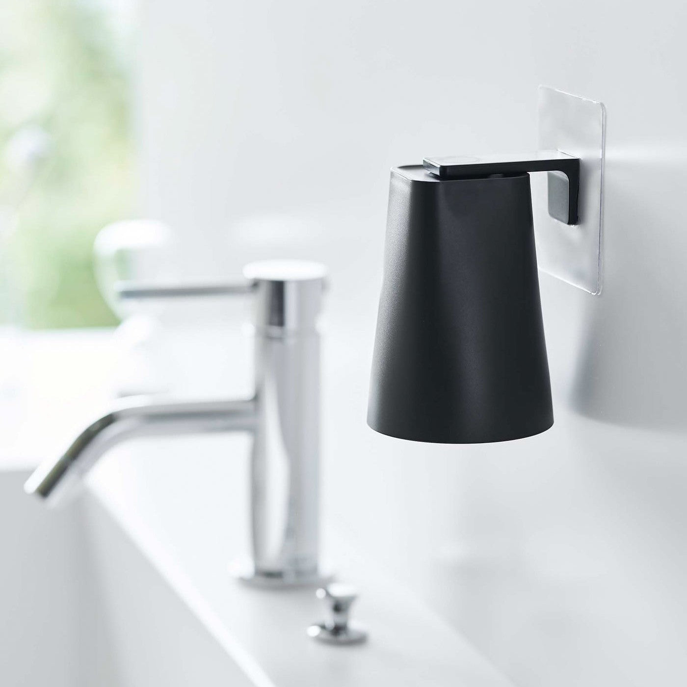 Black Yamazaki Home traceless adhesive magnetic cup installed next to sink