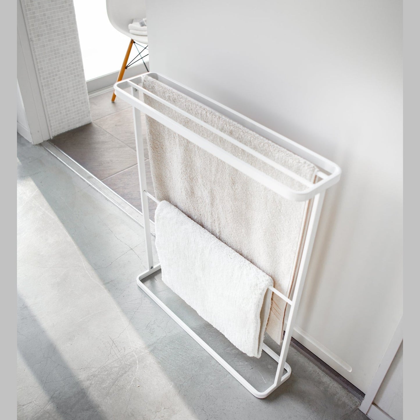 Aerial view of white Bath Towel Hanger holding towels by Yamazaki Home.