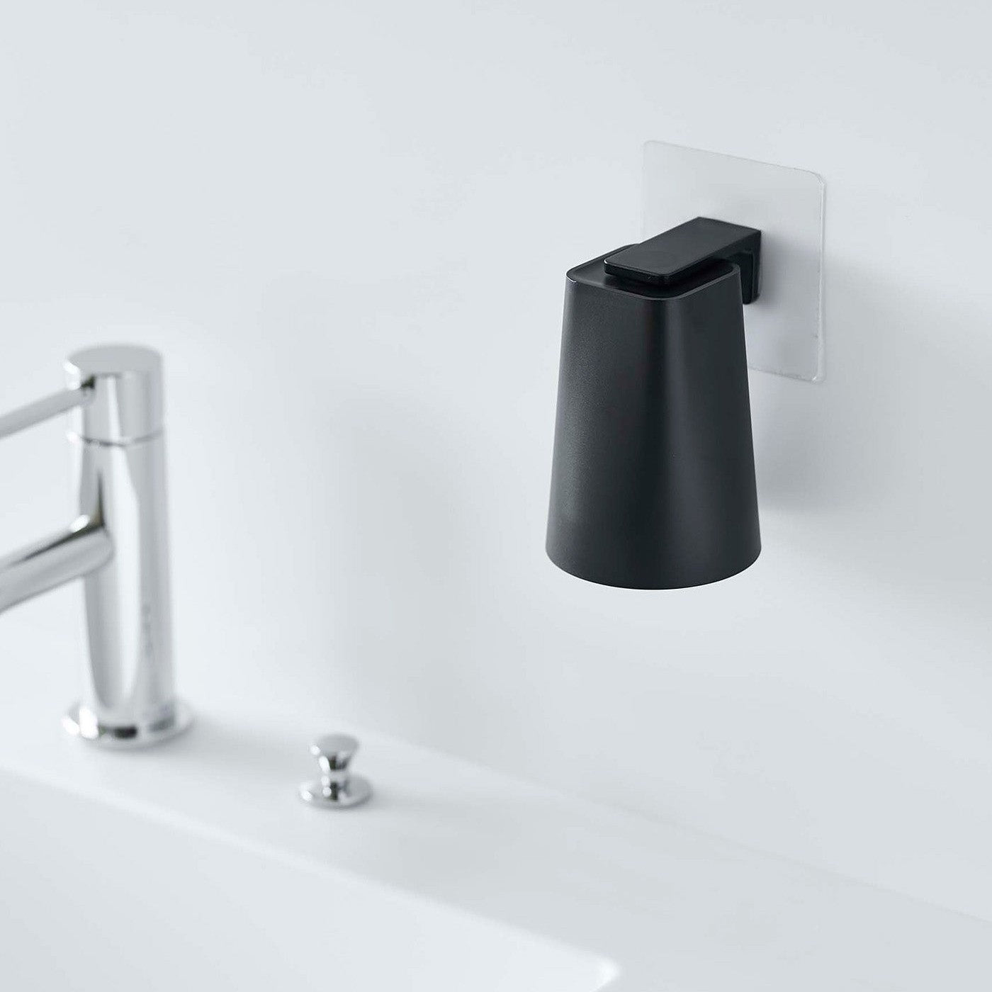 Black Yamazaki Home traceless adhesive magnetic cup installed next to sink