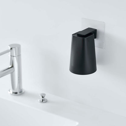 Black Yamazaki Home traceless adhesive magnetic cup installed next to sink