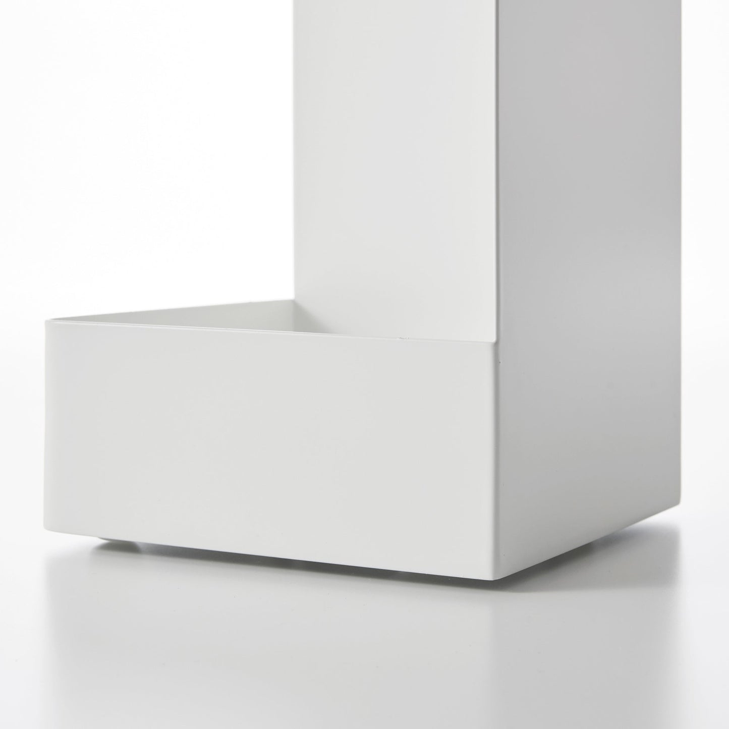 Close up view of bottom of white Yamazaki Home Rolling Bathroom Organizer