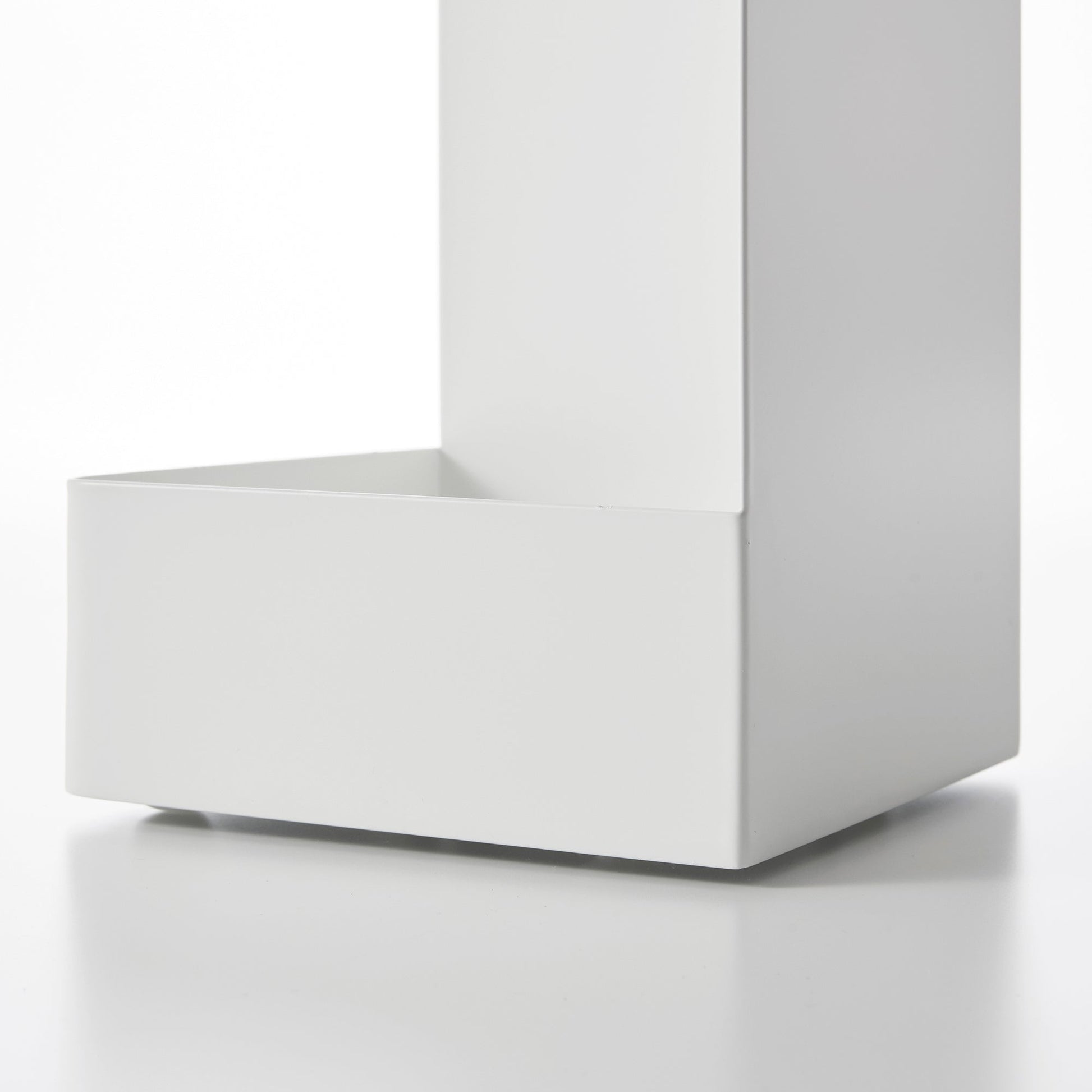 Close up view of bottom of white Yamazaki Home Rolling Bathroom Organizer