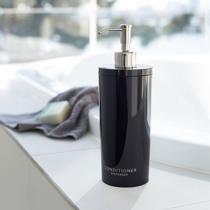 Front view of black Conditioner Dispenser in bathroom by Yamazaki Home.