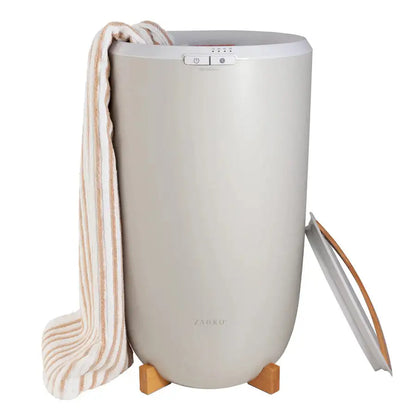 Beige Zadro towel warmer holding striped bath towel with lid open